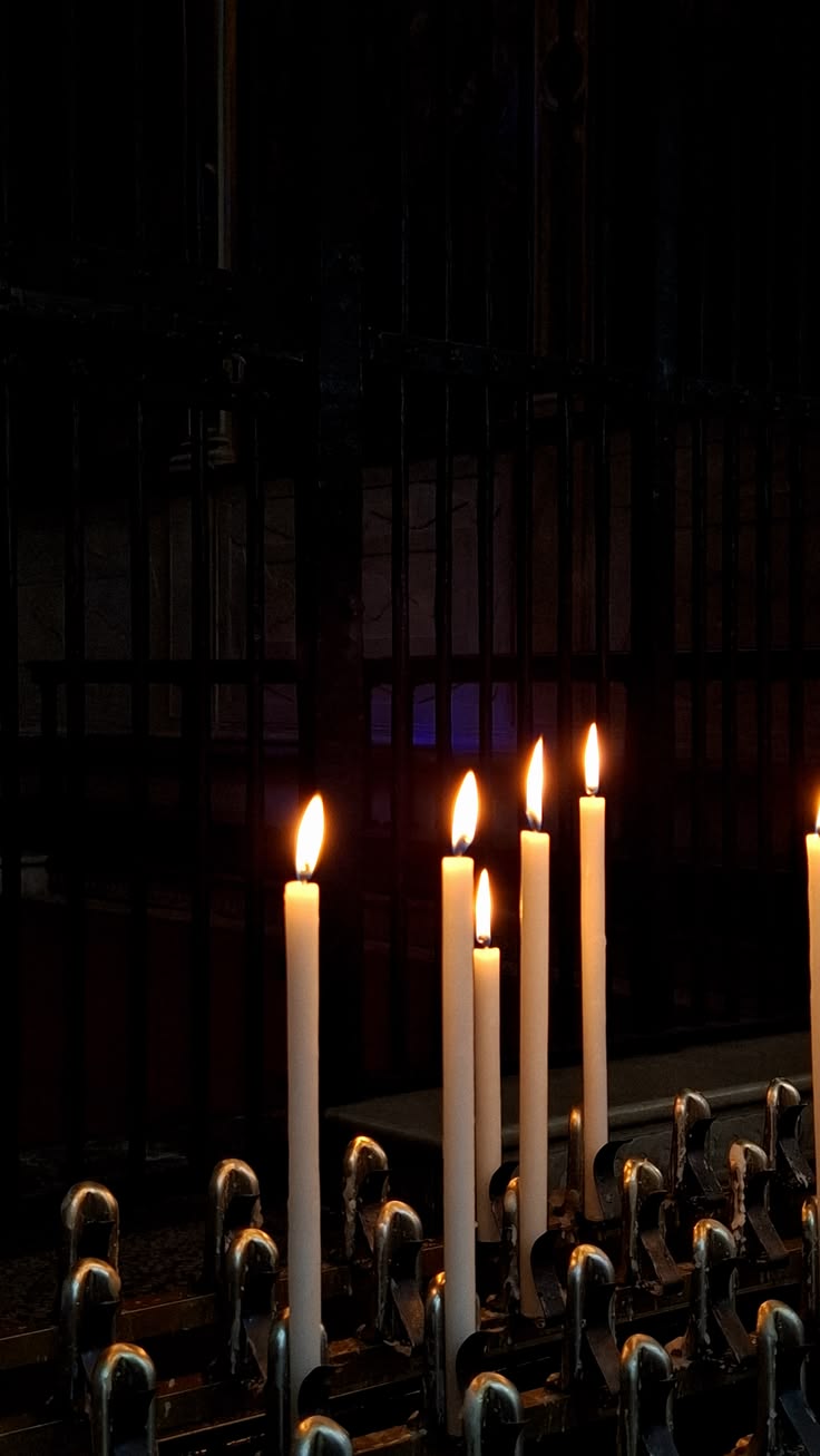 Lit candles in a church, illustrative image.